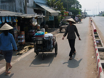 Photo 1 of 14 : The small shops and markets along the road to Cu Chi village, a rice farming community several hours outside of Ho Chi Minh City in South Vietnam.  The village is the site of fields where new varieties of rice are being grown developed in cooperation with South Vietnam's Institute of Agricultural Science.  The Institute is supported by the IAEA's research and technical cooperation programmes for food and agricultural development.  