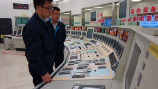 Managing knowledge and experience is key to safe and sustainable operations. Here, two engineers at a control room at China's Qinshan NPP. (Photo: CNNC)
